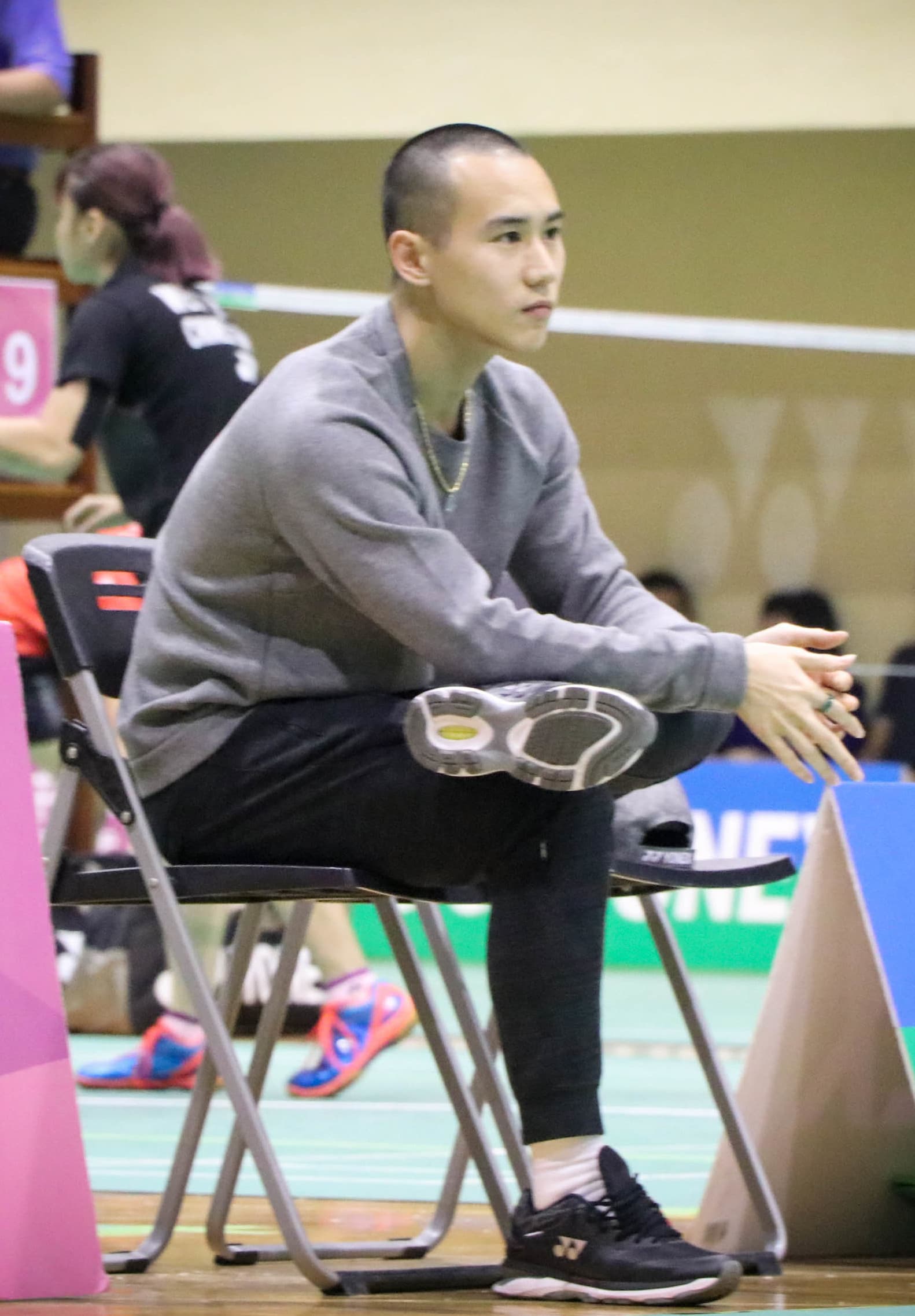 Badminton player reaching for an overhead shot